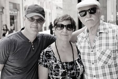 Happy loving senior parents with adult sonの写真素材