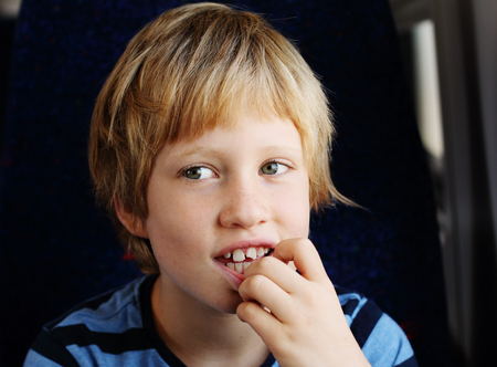 Cute 7 years old boy traveling in the train