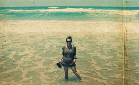 Beautiful young woman walking at the beach.  の写真素材