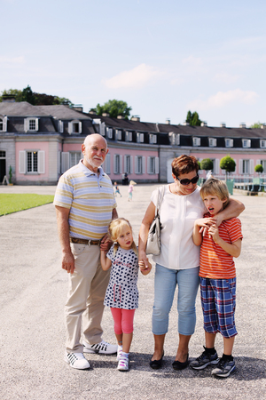 Grandparents With Grandchildren walking together in the parkの写真素材