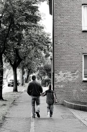 Father and son walking together in European cityの写真素材