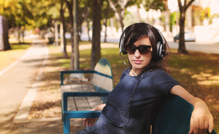 Beautiful Woman with Headphones Outdoorsの写真素材