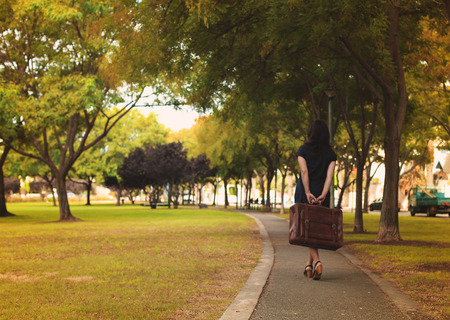 beautiful 35 years old woman  with wintage bag outdoorsの写真素材