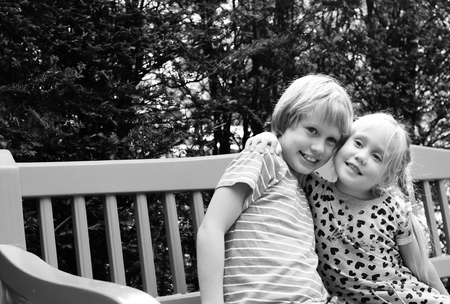 Portrait of happy girl with her autistic brother outdoorsの写真素材