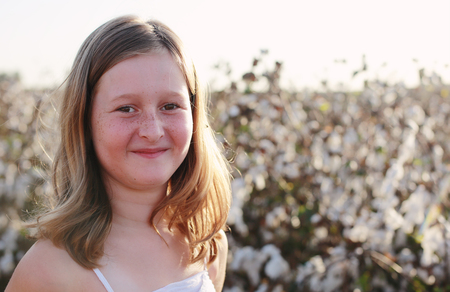 beautiful girl standing in cotton fieldの写真素材
