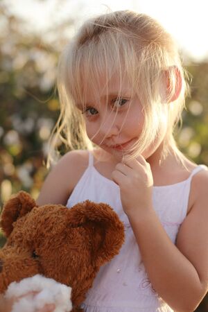5 years old girl standing in the cotton fieldの写真素材
