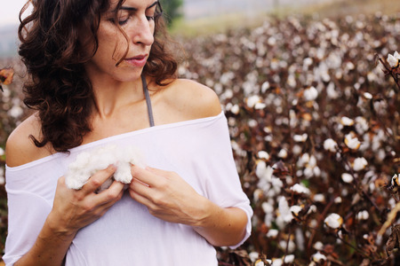 beautiful woman standing in cotton fieldの写真素材