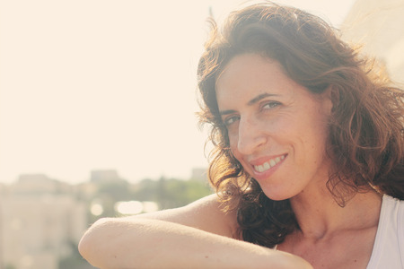 Portrait of beautiful 35 years old woman on sunset colorsの写真素材
