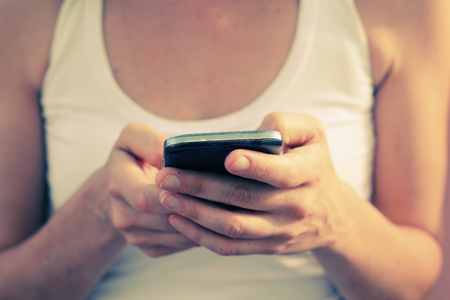 woman's hands with cellphoneの写真素材