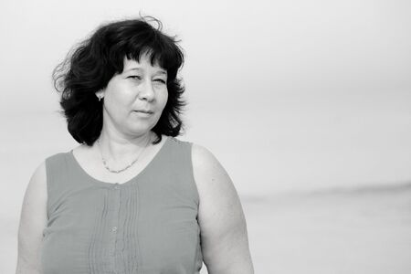 beautiful 40 years old woman standing in beachの写真素材