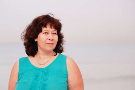beautiful 40 years old woman standing in beachの写真素材