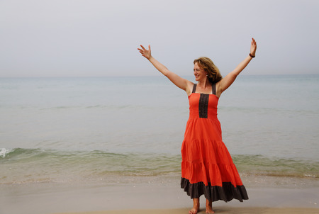 Beautiful woman standing on the beachの写真素材
