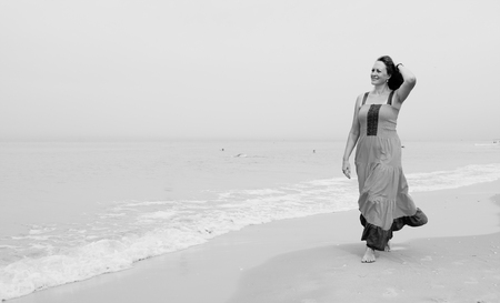 Beautiful woman walking on the beachの写真素材