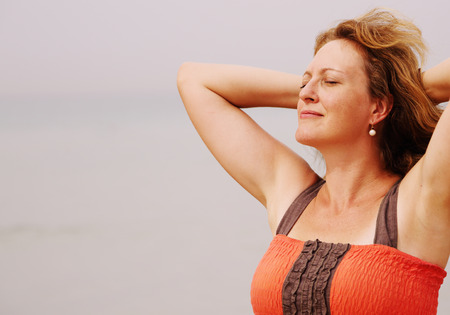 Beautiful woman standing on the beachの写真素材