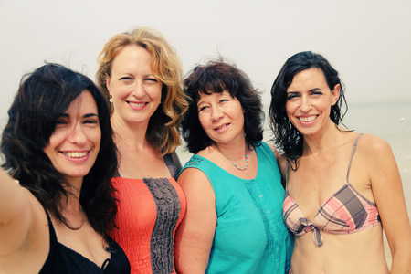 four best girlfriends making selfie-photo at seasideの写真素材