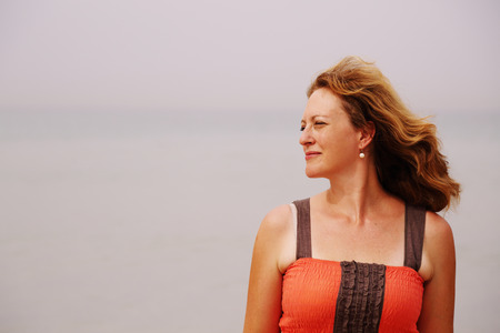 Beautiful woman standing on the beachの写真素材