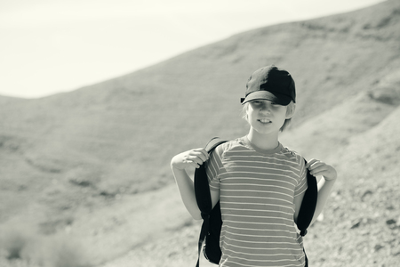 Cute 8 years old boy hiking in  the desertの写真素材