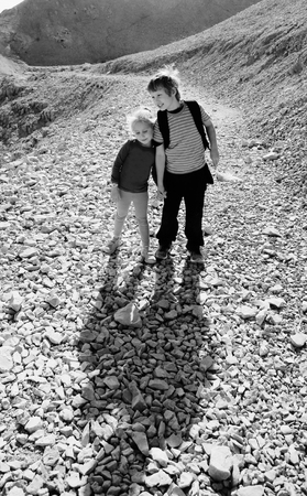 Portrait of happy girl with her autistic brother traveling outdoorsの写真素材