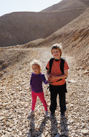 Portrait of happy girl with her autistic brother traveling outdoorsの写真素材