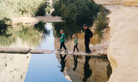 father traveling with two kidsの写真素材