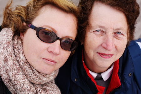 Portrait of beautiful senior woman and her adult daughterの写真素材