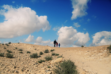 father hiking with two kidsの写真素材