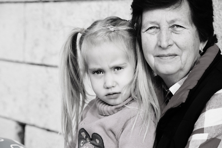 grandmother holding 5 years old granddaughterの写真素材