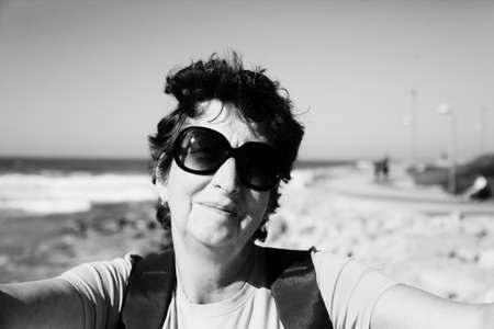 Portrait of happy senior woman travelingの写真素材