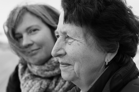 Portrait of beautiful senior woman and her adult daughterの写真素材