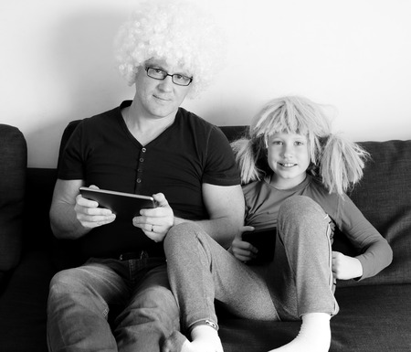 father and son playing games on tabletsの写真素材