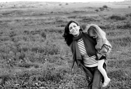 outdoor portrait of a beautiful middle aged mother and daughterの写真素材