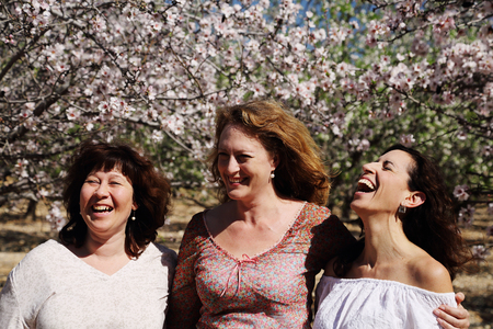 Portrait of three best friends smiling in the gardenの写真素材