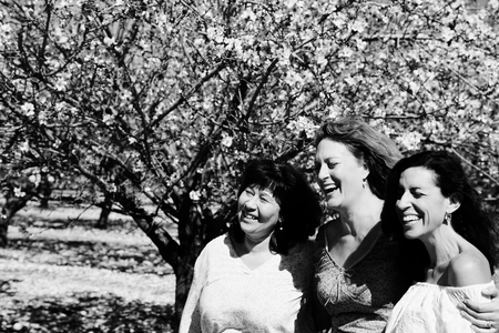 Portrait of three best friends smiling in the gardenの写真素材