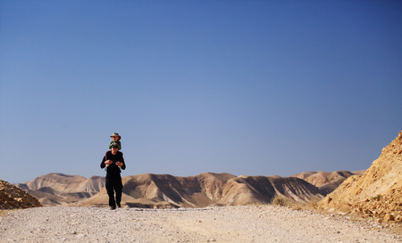 father with daughter hiking in the desertの写真素材