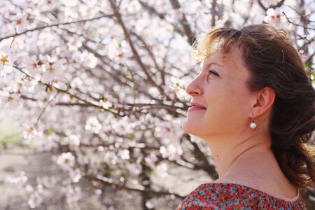 Spring portrait of beautiful 40 years old woman outdoorsの写真素材