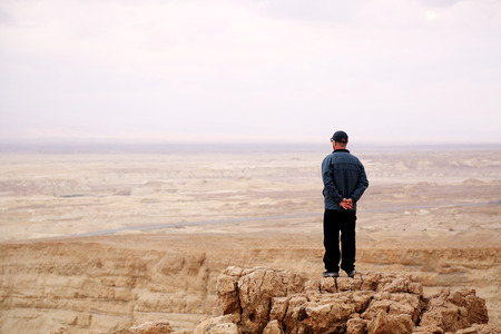 Man standing on mountain hillの写真素材