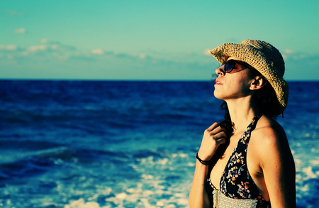 Beautiful 40 years old woman walking on the beach.の写真素材
