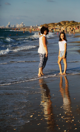 Mother and daughter walking on the beachの写真素材