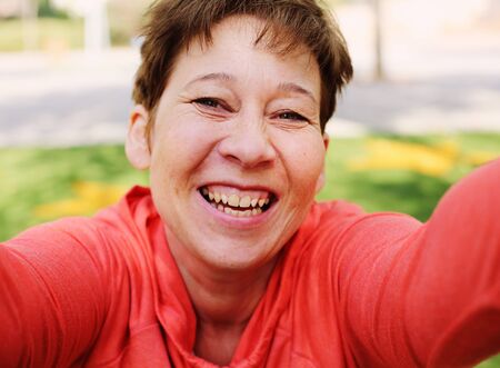 Portrait of beautiful 45 years old woman outdoorsの写真素材