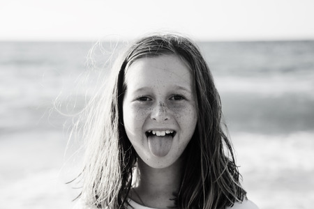 portrait of a real 10 years old girl walking on the beachの写真素材
