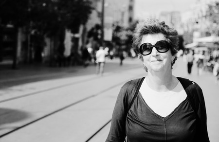 Portrait of cheerful senior woman enjoying the tripの写真素材