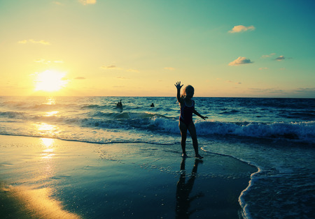 kids playing on the beach at sunsetのeditorial素材