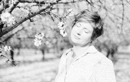 Happy woman in spring blossom park. soft backlightの写真素材