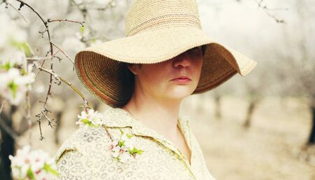 Happy woman in spring blossom park. soft backlightの写真素材