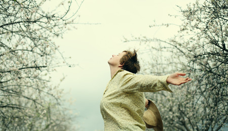 Happy woman in spring blossom park. soft backlightの写真素材