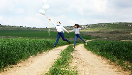 Happy mother and daughter jumping together. Mother day.