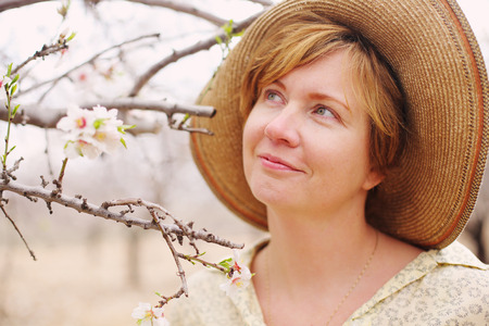 Happy woman in spring blossom park. soft backlightの写真素材