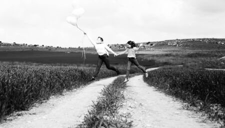 Happy mother and daughter jumping together. Mother day.の写真素材
