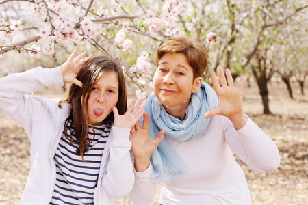 Happy mother and daughter in spring blossom park. Mother day.の写真素材