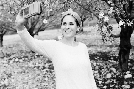 Outdoor portrait of 40 years old woman making selfieの写真素材